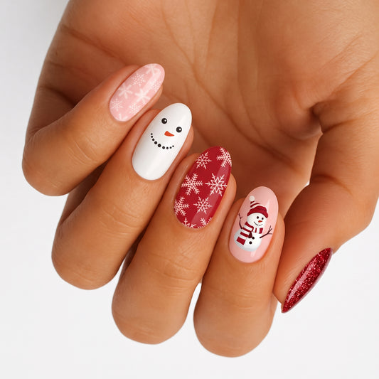 Holiday nail wraps with snowman faces, snowflakes, pink and red glitter accents
