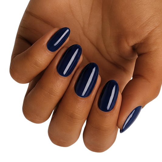 Dark navy blue gel nail wraps on hand displaying elegant glossy finish