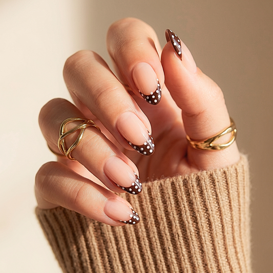 Almond press-on nails with brown French tips and white polka dot accents