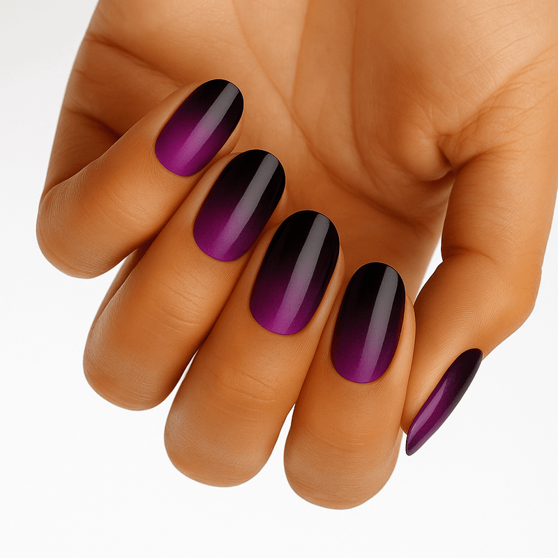 Purple to black ombré gradient nail wraps on hand showing glossy finish manicure