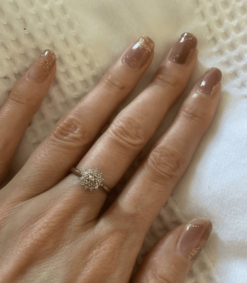 Dusty rose nail wraps with gold foil marble pattern on elegant manicure