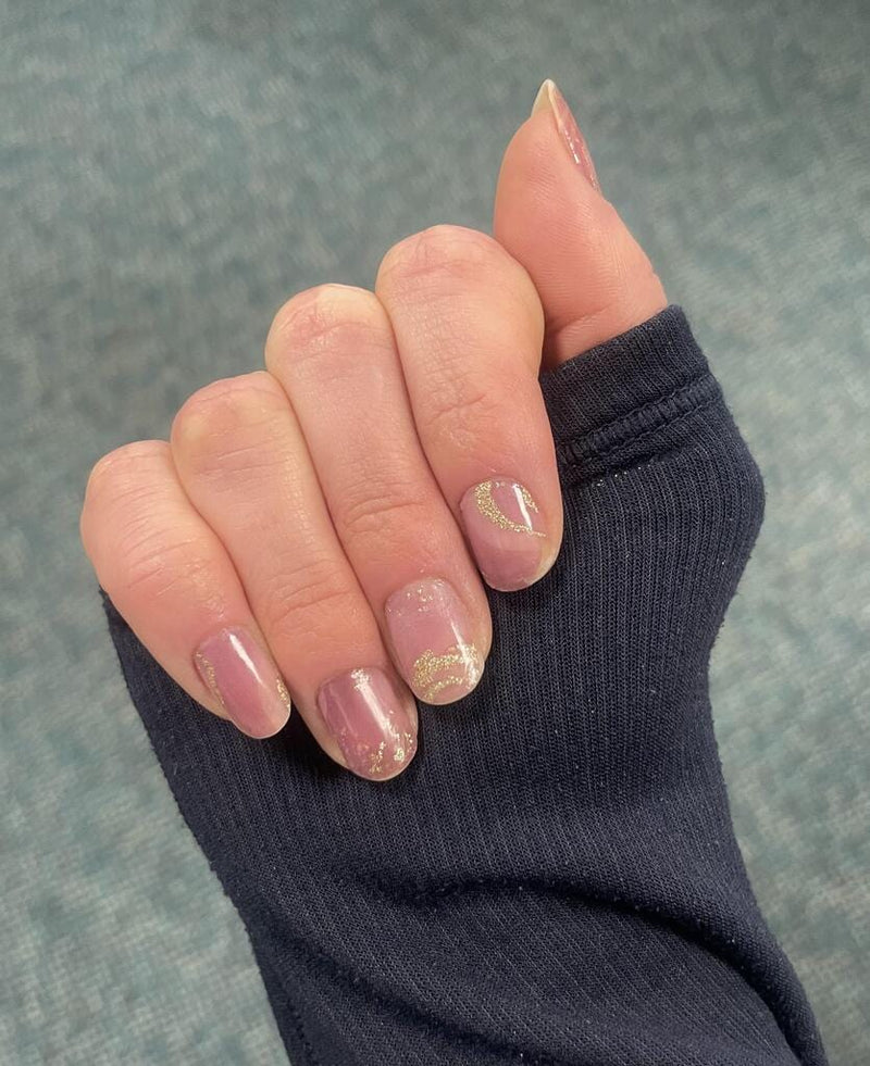 Pink stone marble nail wraps with rose gold foil on hand manicure