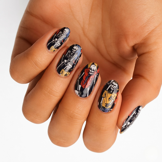 Black semi-cured gel nail wraps with skeleton figures in colorful clothing, Halloween design