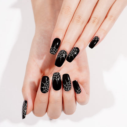 Glossy black press-on nails with white spiderweb design, square shape, Halloween style