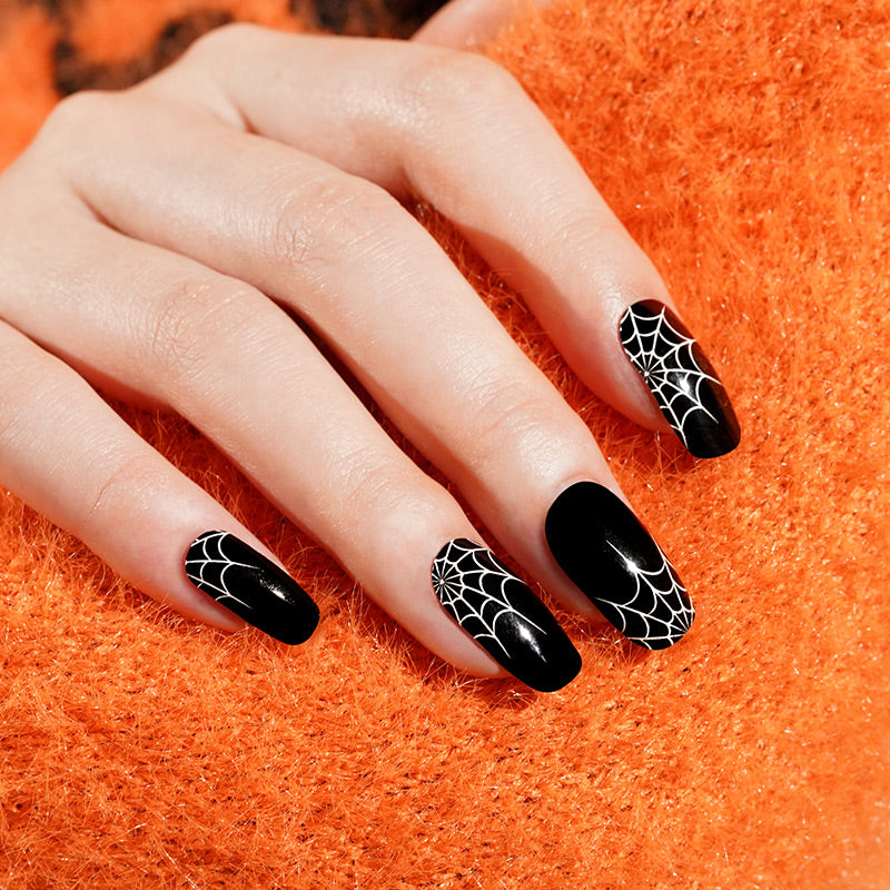 Glossy black nail wraps with white spiderweb accents, coffin shape, Halloween design