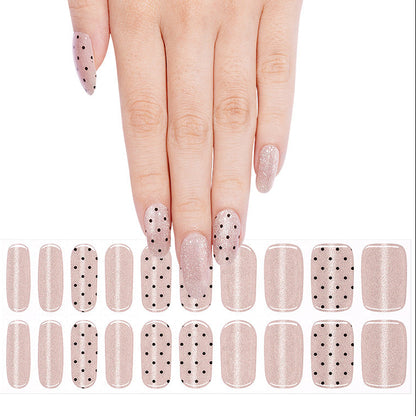 Shimmery nude pink nail wraps with black polka dot accent design, semi-cured gel strips