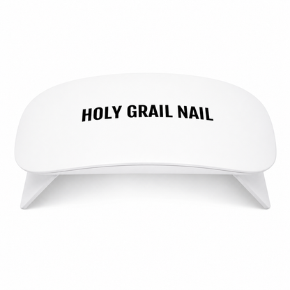 White mini LED lamp for curing semi-cured gel nail wraps, Holy Grail Nail logo.