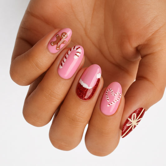 Pink and red glitter nail wraps with gingerbread man, candy cane and gift bow designs
