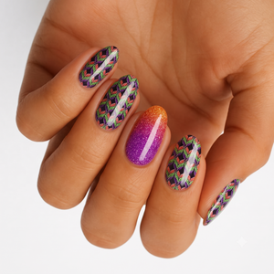 Nail wraps with green-purple chevron pattern, orange-to-purple glitter ombre accent nail