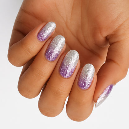 Silver and lilac glitter ombré nail wraps with sparkling diagonal shading on almond nails