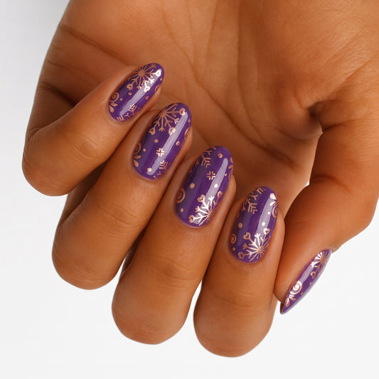 Purple nail wraps with gold metallic snowflake and festive foil designs
