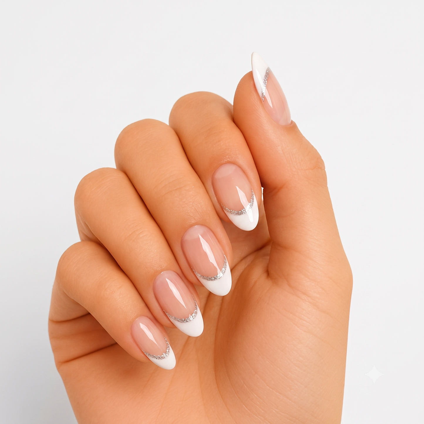 Glossy nude press-on nails with white French tips outlined in silver glitter.