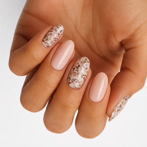 Glossy nude nail wraps with ditsy floral accent nails in soft pink and sage tones