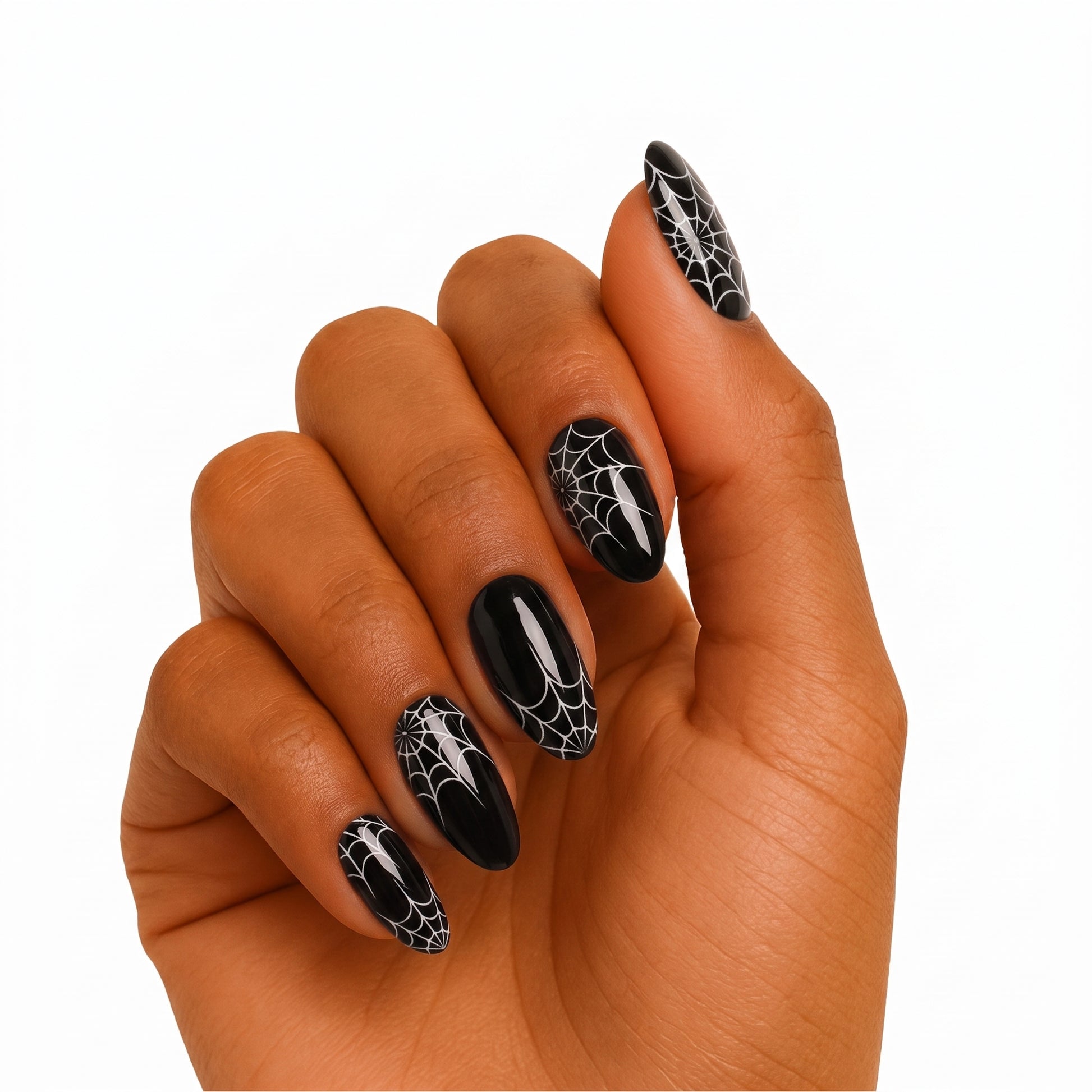 Glossy black almond press-on nails with white spiderweb Halloween design.