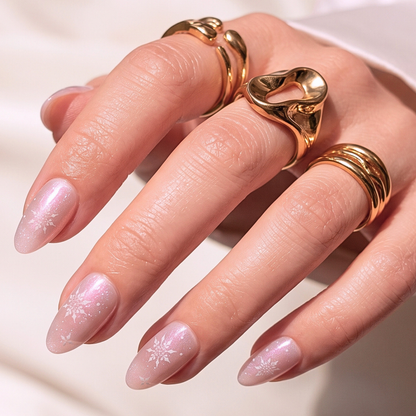Soft gel press-ons, short almond, sheer pink shimmer with white snowflake accents