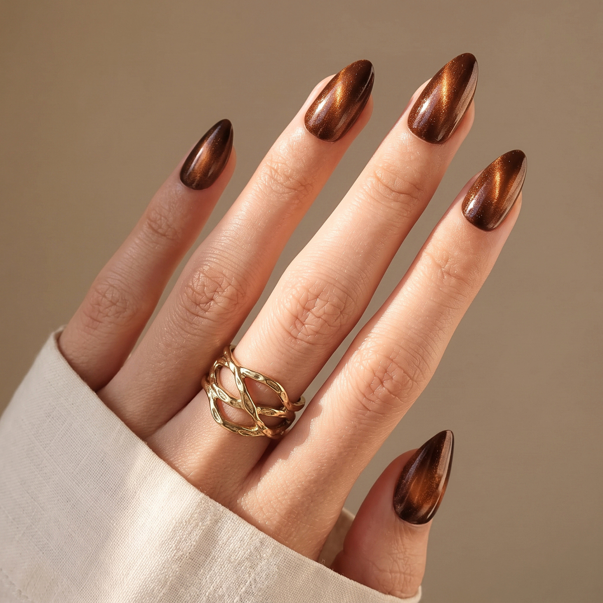 Chocolate brown cat-eye chrome press-on nails with almond shape