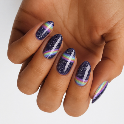 Navy glitter nail wraps with iridescent rainbow streak design, almond shape