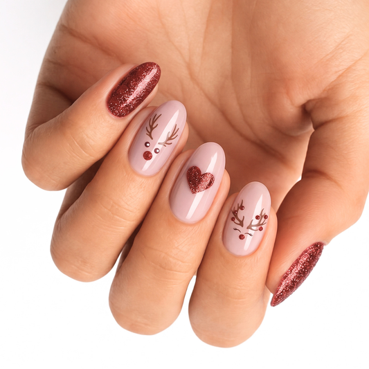 Nude nail wraps with reindeer face design, glitter heart accent and red glitter tips