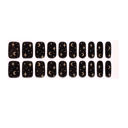 Black semi-cured gel nail wraps with gold celestial moon and star design