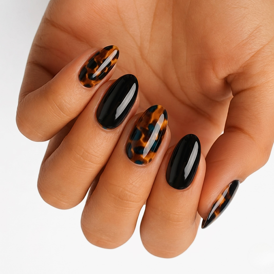 Glossy black nail wraps with amber tortoiseshell accent nails, almond shape press-ons