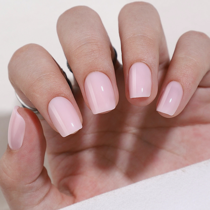 Sheer light pink glossy semi-cured gel nail wraps on square-shaped nails.