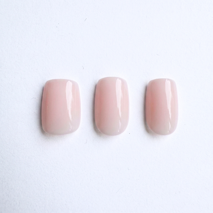 Sheer nude pink glossy press-on nails, square-round shape, three tones shown