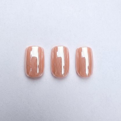 Glossy nude peach press-on nails, solid sheer color, squoval shape