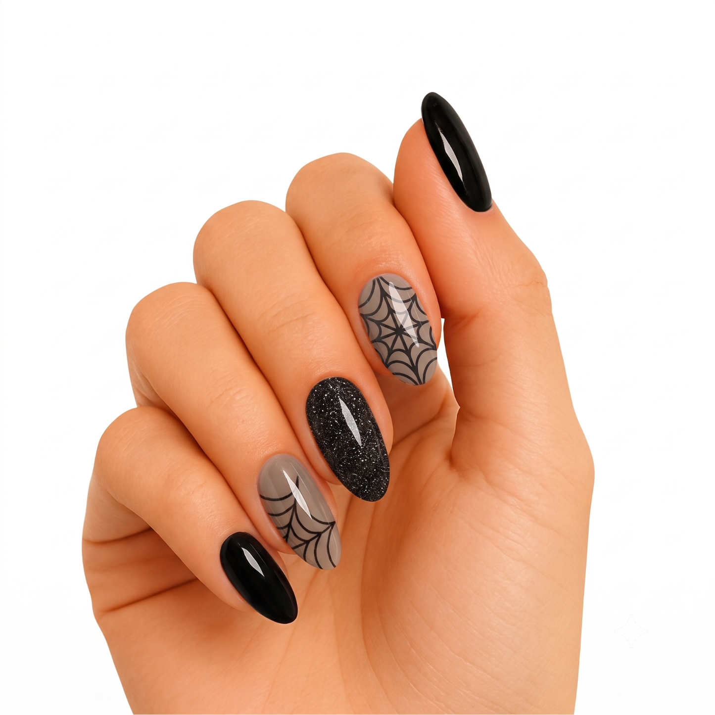 Glossy black and nude press-on nails with black glitter accent and spiderweb designs.