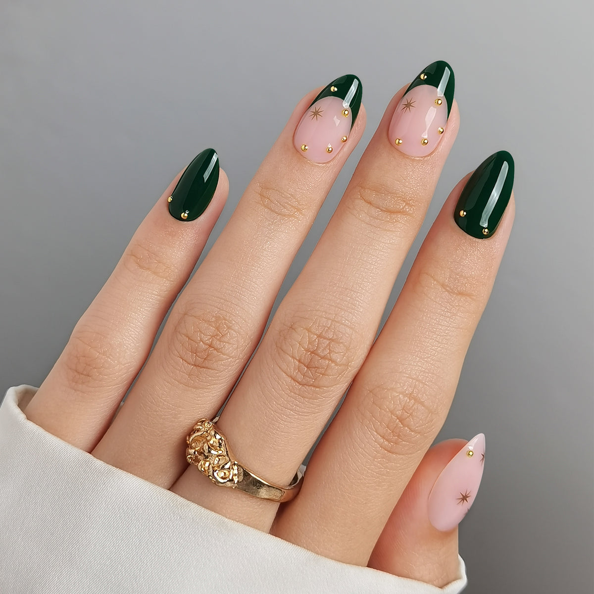 Dark green glossy press-on nails with nude accents, gold star studs and beads