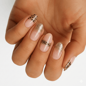 Nude pink nail wraps with gold leopard print and glitter accents on hand