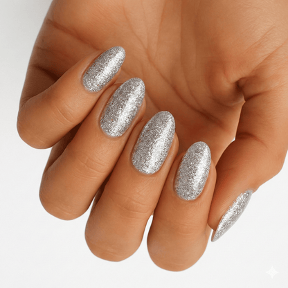 Hand displaying silver glitter nail wraps with metallic finish for elegant at-home manicure