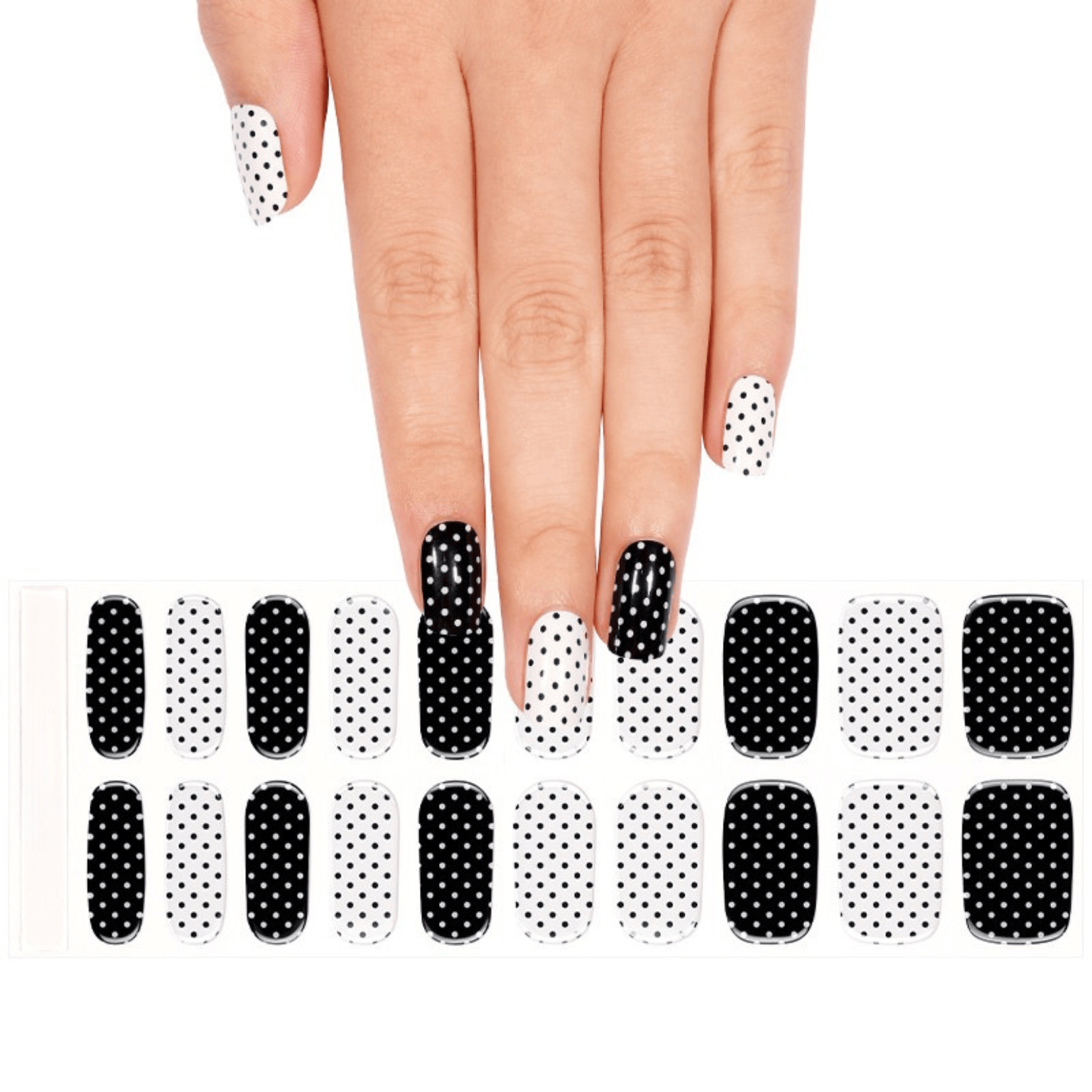 Monochrome polka dot gel nail wraps on hand with matching nail wrap sheet below