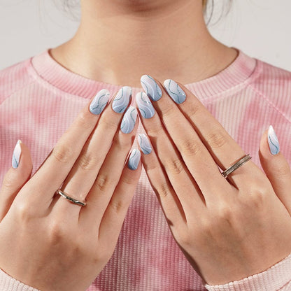 Blue marble nail art with wave pattern on both hands displayed together