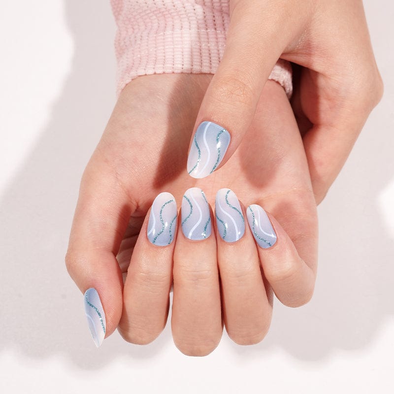 Powder blue marble gel nails with flowing wave design on cupped hands