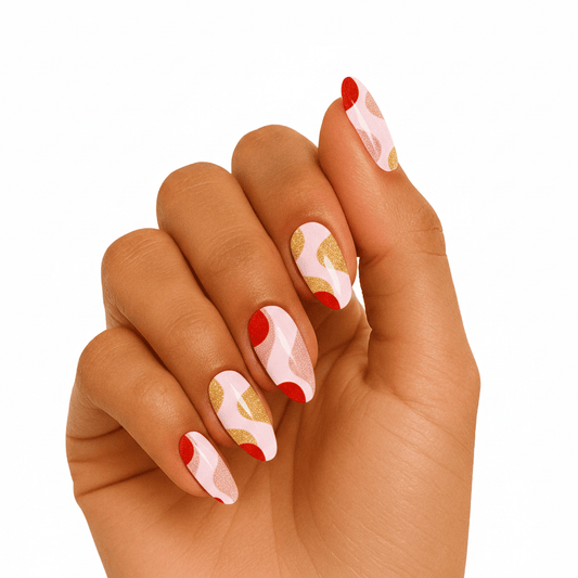 Abstract coral pink and gold swirl gel nails on hand showing retro artistic nail art
