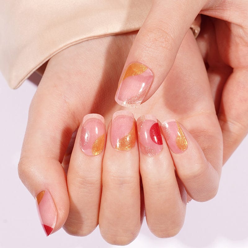Hands showing retro gel nails with pink coral red gold abstract nail art