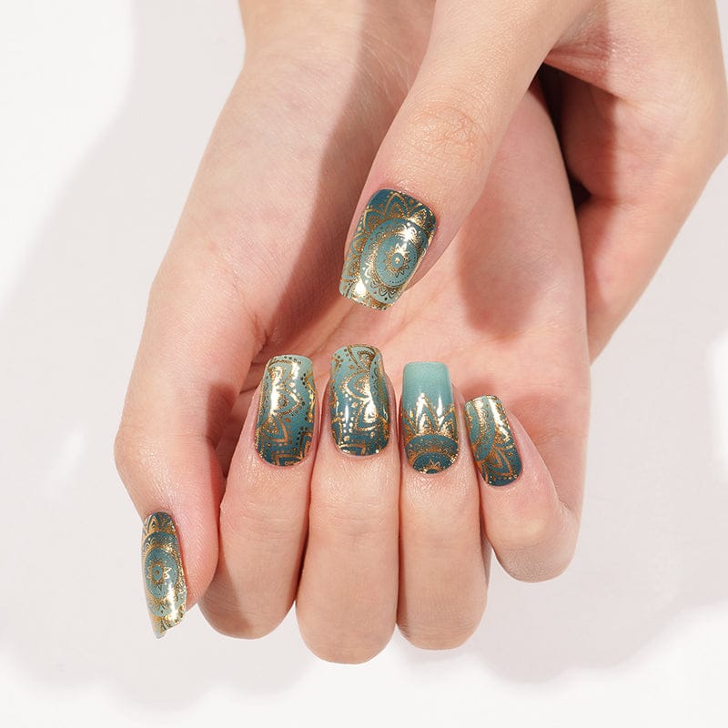 Turquoise gel nail wraps with metallic gold mandala design on both hands manicure