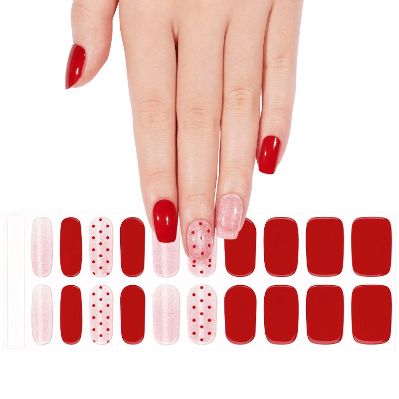 Hand selecting from red and pink dotted gel nail wraps sheet for DIY manicure