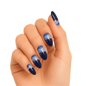 Blue gradient gel nails on hand showing stormy ombre nail art design